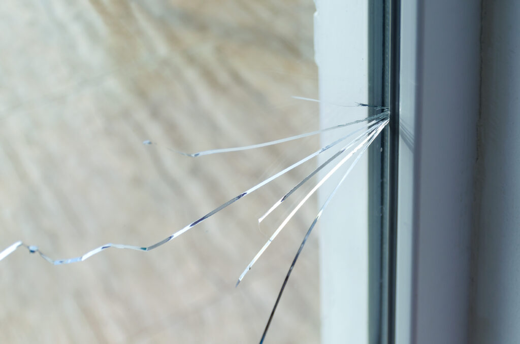 Close-up of cracked glass window.