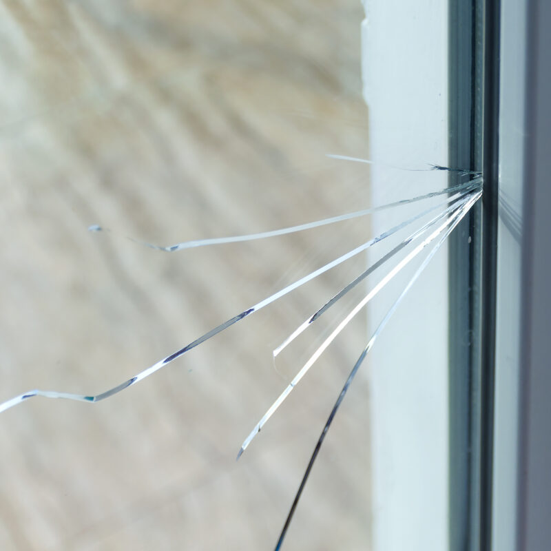 Close-up of cracked glass window.