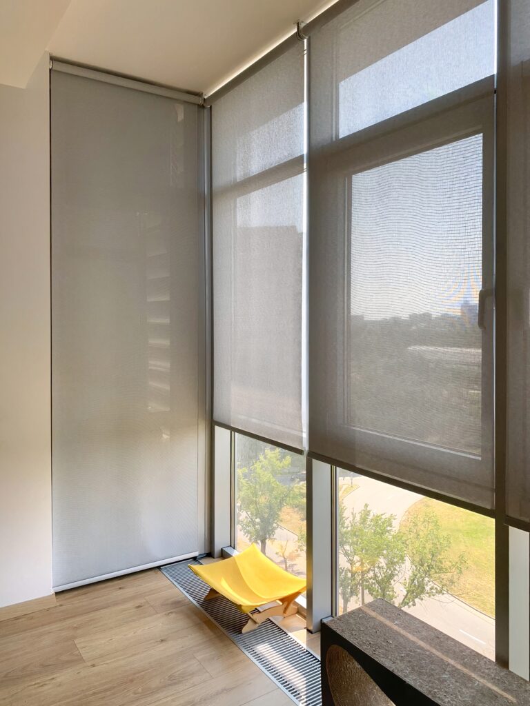 Sunny room with yellow chair and sheer window blinds