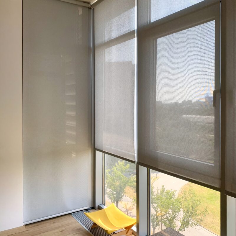 Sunny room with yellow chair and sheer window blinds