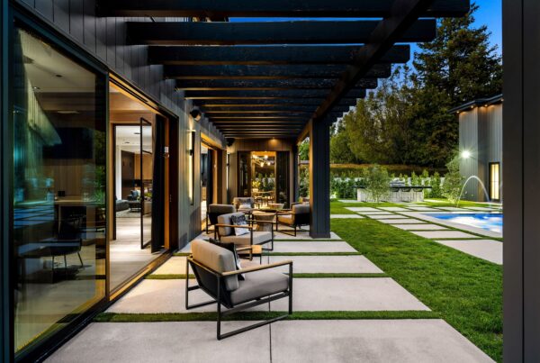 Modern outdoor patio with stylish furniture and lighting